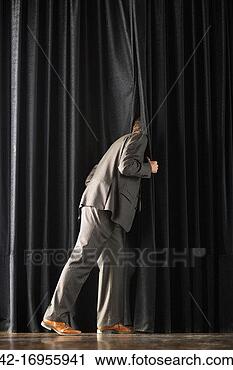 Stock Photography - man looking behind 
theater curtain. 
fotosearch - search 
stock photos, 
pictures, images, 
and photo clipart