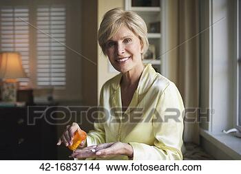 Stock Photo - older woman taking 
pill. fotosearch 
- search stock 
photos, pictures, 
images, and photo 
clipart