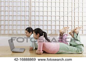 Stock Photograph - two pre-teen girls 
using laptop. 
fotosearch - search 
stock photos, 
pictures, images, 
and photo clipart