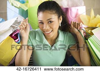 Stock Photography - teenage girl surrounded 
by shopping bags. 
fotosearch - search 
stock photos, 
pictures, images, 
and photo clipart