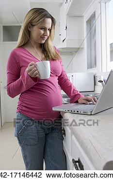 Stock Photo - young pregnant 
woman with laptop 
and coffee. fotosearch 
- search stock 
photos, pictures, 
images, and photo 
clipart