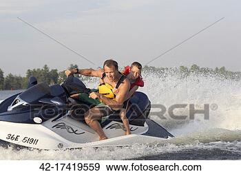 Stock Photograph - man jet skiing 
with son. fotosearch 
- search stock 
photos, pictures, 
images, and photo 
clipart