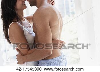 Stock Photography - couple embracing 
at home. fotosearch 
- search stock 
photos, pictures, 
images, and photo 
clipart