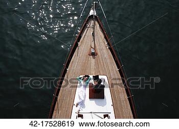 Stock Photograph - couple relaxing 
on boat. fotosearch 
- search stock 
photos, pictures, 
images, and photo 
clipart