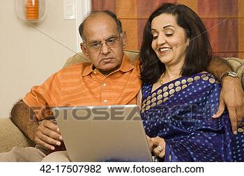 Stock Photo - middle aged couple 
using laptop. 
fotosearch - search 
stock photos, 
pictures, images, 
and photo clipart