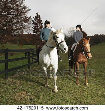 Stock Image - equestrians riding 
horses in paddock. 
fotosearch - search 
stock photos, 
pictures, images, 
and photo clipart