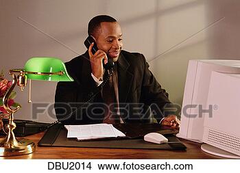 Stock Photo - man on telephone 
and computer at 
office. fotosearch 
- search stock 
photos, pictures, 
images, and photo 
clipart