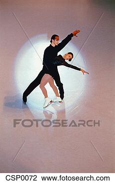 Stock Photo - ice skating pair 
in the spotlight. 
fotosearch - search 
stock photos, 
pictures, images, 
and photo clipart