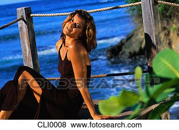 Stock Photo - woman relaxing 
on a pier. fotosearch 
- search stock 
photos, pictures, 
images, and photo 
clipart
