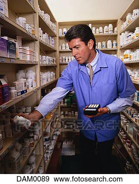 Stock Photograph - pharmacist checking 
drug supplies. 
fotosearch - search 
stock photos, 
pictures, images, 
and photo clipart