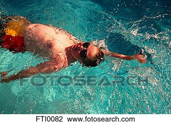 Stock Photo - boy swimming backstroke 
in pool. fotosearch 
- search stock 
photos, pictures, 
images, and photo 
clipart
