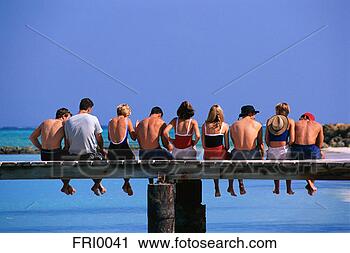 Stock Photography - friends sitting 
on dock. fotosearch 
- search stock 
photos, pictures, 
images, and photo 
clipart