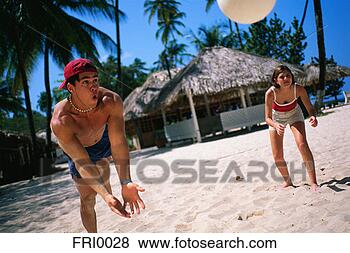 Stock Photo - young man diving 
for volleyball 
on beach. fotosearch 
- search stock 
photos, pictures, 
images, and photo 
clipart