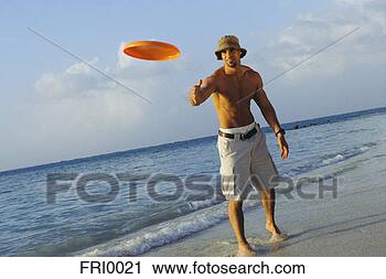 Stock Photography - young man throwing 
red frisbee. fotosearch 
- search stock 
photos, pictures, 
images, and photo 
clipart