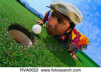 Stock Photo - golfer blowing 
a golf ball into 
the hole. fotosearch 
- search stock 
photos, pictures, 
images, and photo 
clipart