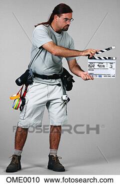 Stock Photography - film crew member 
using a clapper 
board. fotosearch 
- search stock 
photos, pictures, 
images, and photo 
clipart