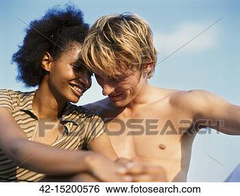 Stock Photo - young couple at 
beach. fotosearch 
- search stock 
photos, pictures, 
images, and photo 
clipart