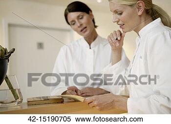 Stock Image - two doctors reviewing 
medical record. 
fotosearch - search 
stock photos, 
pictures, images, 
and photo clipart