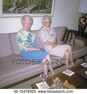 Stock Image - two mature women 
on sofa. fotosearch 
- search stock 
photos, pictures, 
images, and photo 
clipart
