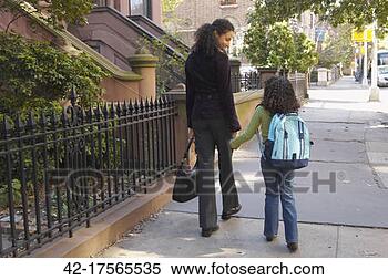 Stock Image - mother and daughter 
walking to school. 
fotosearch - search 
stock photos, 
pictures, images, 
and photo clipart