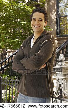 Stock Photo - smiling man standing 
by gate. fotosearch 
- search stock 
photos, pictures, 
images, and photo 
clipart