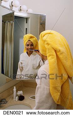 Stock Photography - woman brushing 
her teeth in bathroom 
mirror. fotosearch 
- search stock 
photos, pictures, 
images, and photo 
clipart