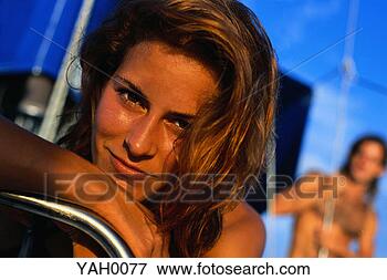 Picture - woman relaxing 
on a sailboat. 
fotosearch - search 
stock photos, 
pictures, images, 
and photo clipart