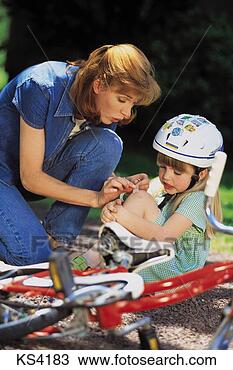 Stock Photo - lifestyles - families, 
 accident,  assisting, 
 bicycle helmet. 
fotosearch - search 
stock photos, 
pictures, images, 
and photo clipart