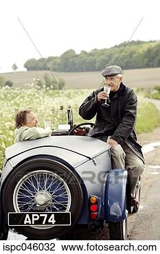 Stock Photo - senior couple 
drinking wine 
in the car. fotosearch 
- search stock 
photos, pictures, 
images, and photo 
clipart