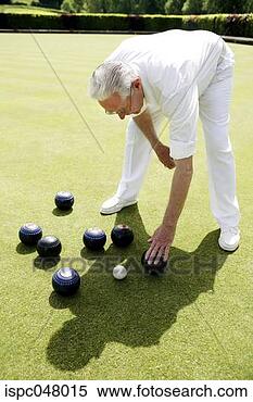 Stock Image - man bending down 
to pick up bowling 
balls. fotosearch 
- search stock 
photos, pictures, 
images, and photo 
clipart