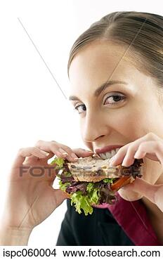 Stock Photo - businesswoman 
biting into a 
sandwich. fotosearch 
- search stock 
photos, pictures, 
images, and photo 
clipart