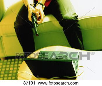 Clipart - man aiming a gun 
at a laptop. fotosearch 
- search clipart, 
illustration, 
drawings and vector 
eps graphics images