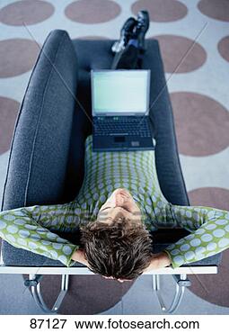 Stock Illustration - overhead view 
of young man using 
laptop. fotosearch 
- search clipart, 
illustration, 
drawings and vector 
eps graphics images