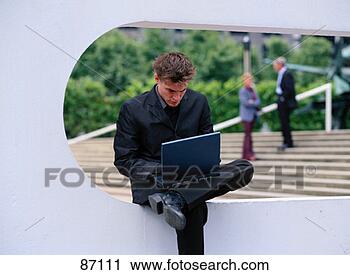 Clipart - young businessman 
on laptop outdoors. 
fotosearch - search 
clipart, illustration, 
drawings and vector 
eps graphics images