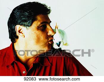 Stock Photo - man kissing cockatoo 
on his shoulder. 
fotosearch - search 
stock photos, 
pictures, images, 
and photo clipart