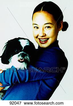 Picture - teenage girl with 
shiatsu dog. fotosearch 
- search stock 
photos, pictures, 
images, and photo 
clipart