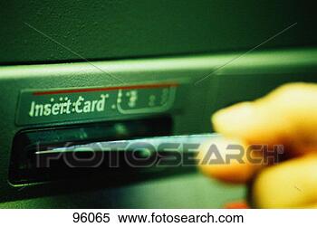 Stock Image - man inserting 
a debit card into 
an atm. fotosearch 
- search stock 
photos, pictures, 
images, and photo 
clipart