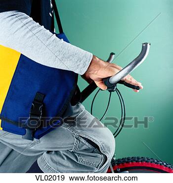 Stock Photograph - close-up of a 
young man on a 
bicycle. fotosearch 
- search stock 
photos, pictures, 
images, and photo 
clipart