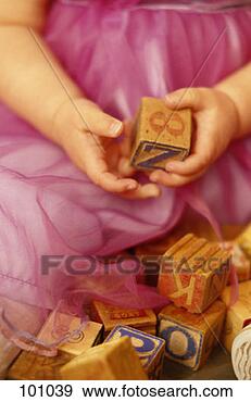 Stock Photograph - baby girl holding 
toy block. fotosearch 
- search stock 
photos, pictures, 
images, and photo 
clipart