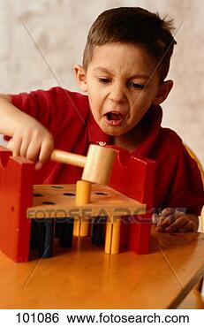 Stock Photo - boy playing with 
toy hammer and 
pegs. fotosearch 
- search stock 
photos, pictures, 
images, and photo 
clipart