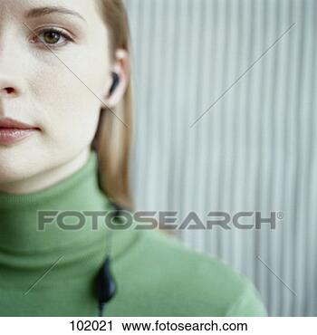 Stock Photography - young woman wearing 
hands free device. 
fotosearch - search 
stock photos, 
pictures, images, 
and photo clipart