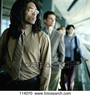 Stock Photography - business people 
on a moving walkway 
in an airport. 
fotosearch - search 
stock photos, 
pictures, images, 
and photo clipart