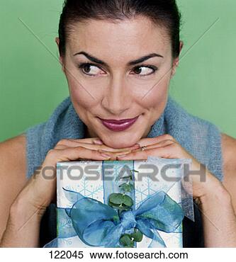 Stock Image - portrait of a 
woman with a christmas 
present. fotosearch 
- search stock 
photos, pictures, 
images, and photo 
clipart