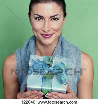 Stock Photo - woman giving a 
christmas present. 
fotosearch - search 
stock photos, 
pictures, images, 
and photo clipart