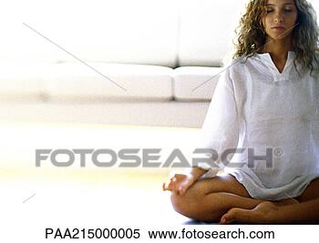 Stock Image - woman sitting 
in lotus position. 
fotosearch - search 
stock photos, 
pictures, images, 
and photo clipart