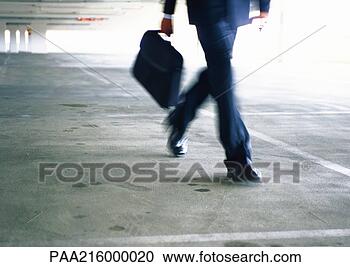 Stock Photography - businessman walking, 
lower section, 
blurred. fotosearch 
- search stock 
photos, pictures, 
images, and photo 
clipart