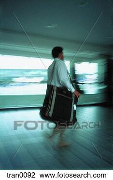 Stock Photo - flying, blur, 
daylight, corridor, 
businessman, hurrying, 
airport. fotosearch 
- search stock 
photos, pictures, 
images, and photo 
clipart