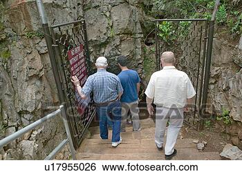 Stock Photo - tourists walking 
into cave. fotosearch 
- search stock 
photos, pictures, 
images, and photo 
clipart