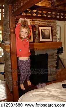 Stock Photography - young girl hanging 
from bed. fotosearch 
- search stock 
photos, pictures, 
images, and photo 
clipart