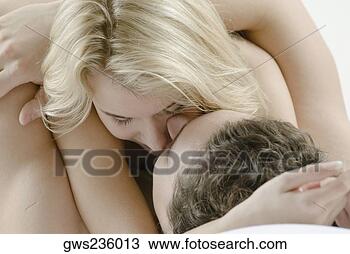 Stock Photo - close-up of a 
young couple romancing 
on the bed. fotosearch 
- search stock 
photos, pictures, 
wall murals, images, 
and photo clipart